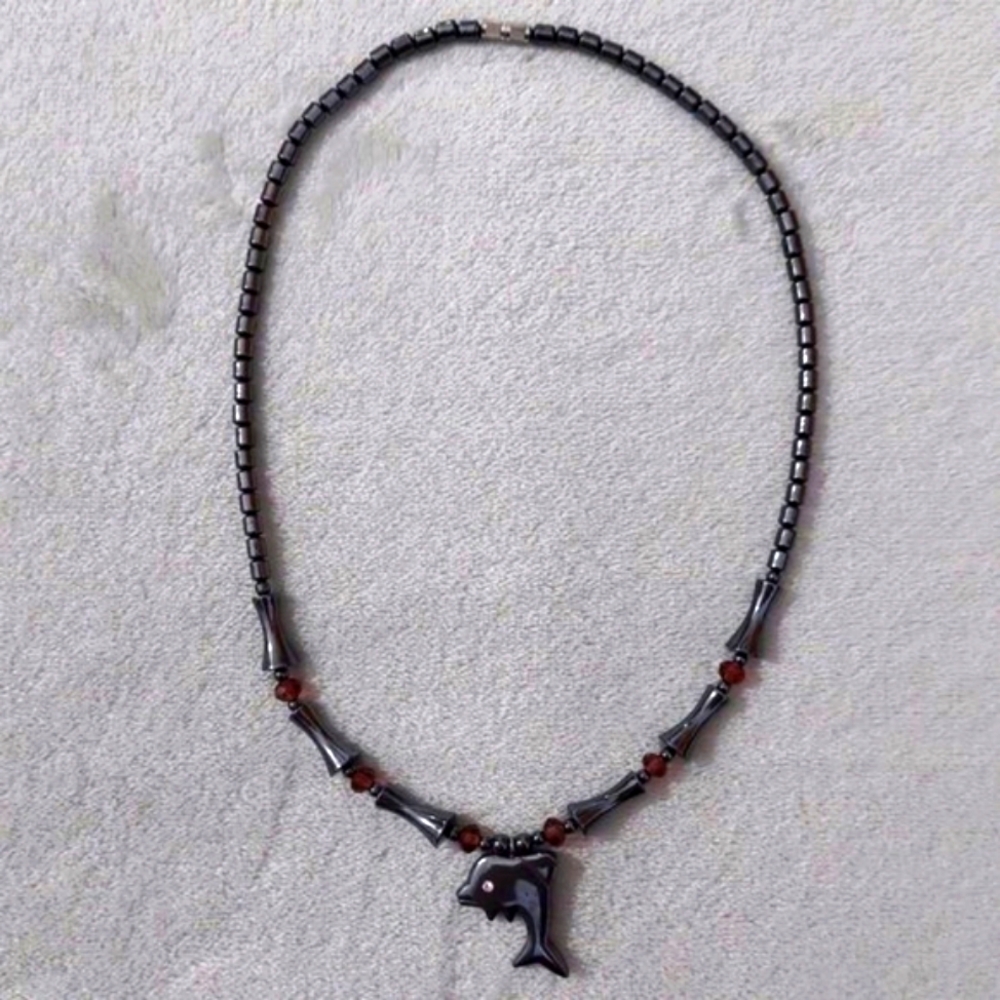Black metallic dolphin necklace with pink gems